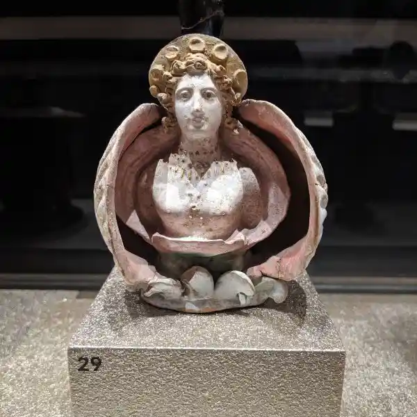 Greek lekythos showing a bust of Aphrodite Anadyomene rising from an open shell, from Tanagra, Boeotia